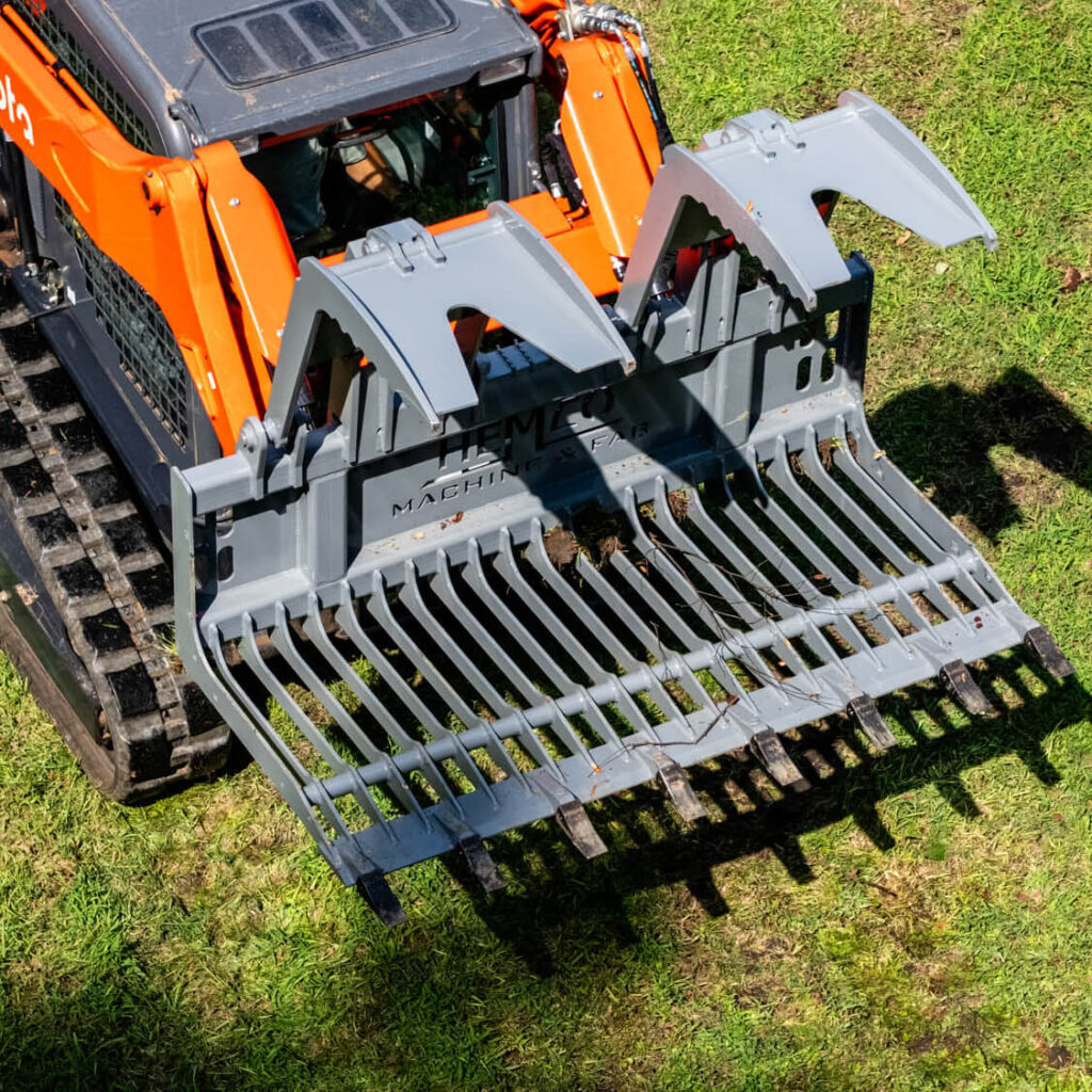 HEMCO Skid Steer in action with grapples open